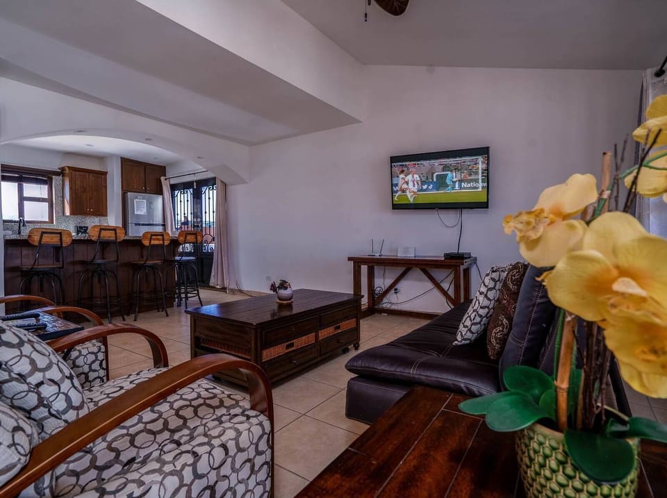 A view of the comfortable living area focused on the entertainment center, featuring a large TV for relaxing movie nights and downtime.
