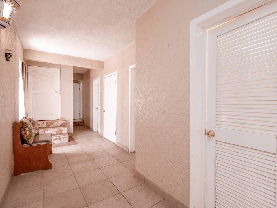 This central hallway in Casa Vista del Mar connects all five bedrooms and five bathrooms — keeping your group moving freely without crowding the living areas.