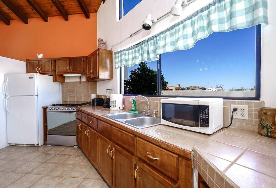 Fully equipped kitchen at Casa Palos Verdes in El Dorado Ranch San Felipe Baja California MX — microwave, stove, and full-size refrigerator included.