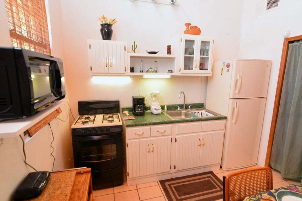 Full kitchen with refrigerator, microwave, and cookware at Casa Rubio del Mar in San Felipe BC Mexico — perfect for home cooking .