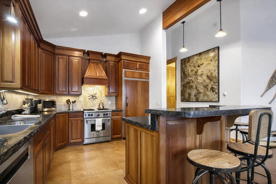 Cook memorable meals in your gourmet kitchen, featuring rich wood cabinetry, granite countertops, and professional-grade appliances that make every culinary adventure a joy. Unit A
