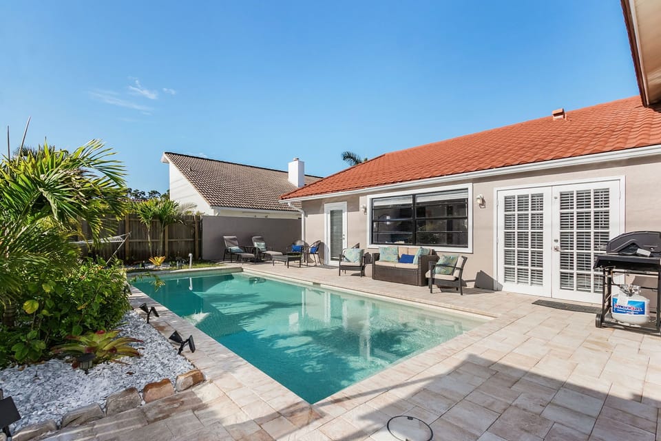 Lanai/Pool area featuring plenty of outdoor seating, hammock, and BBQ gas grill.