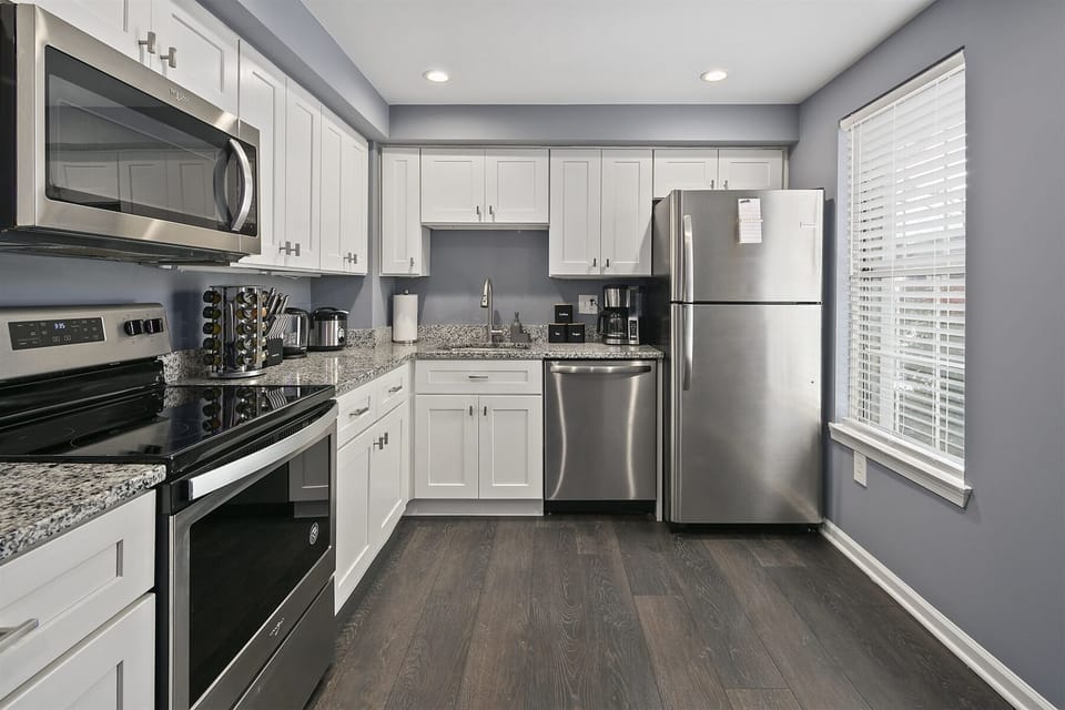 Kitchen cabinetry equipped with cooking/dining essentials
