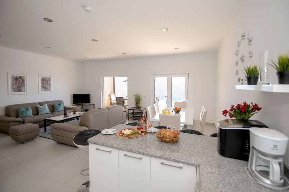 Lounge area opening onto the terrace and view to the sea
