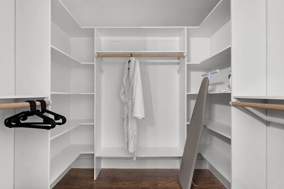Walk-in closet located in primary suite, foldaway bed also located here