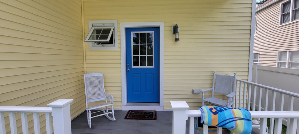 Cute front porch on the lower level with more vintage chairs. 