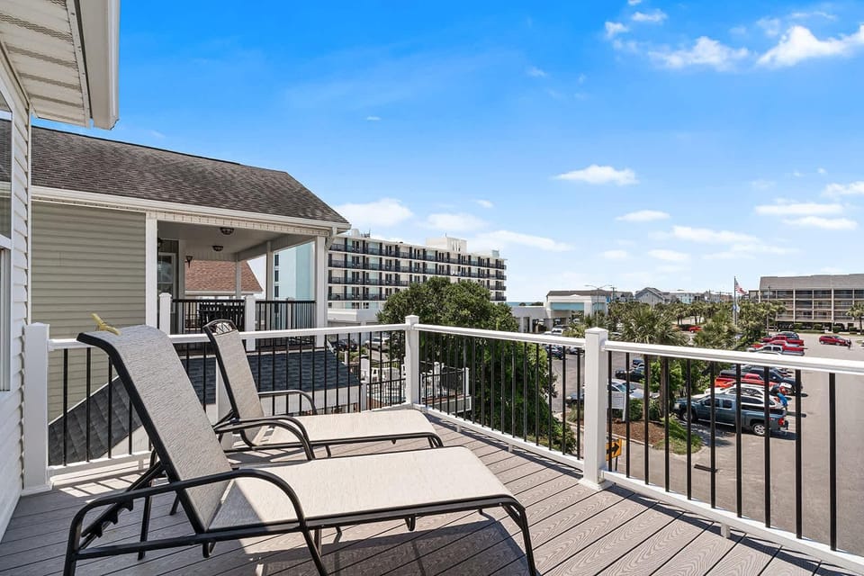 Sunny balcony retreat with loungers and city views