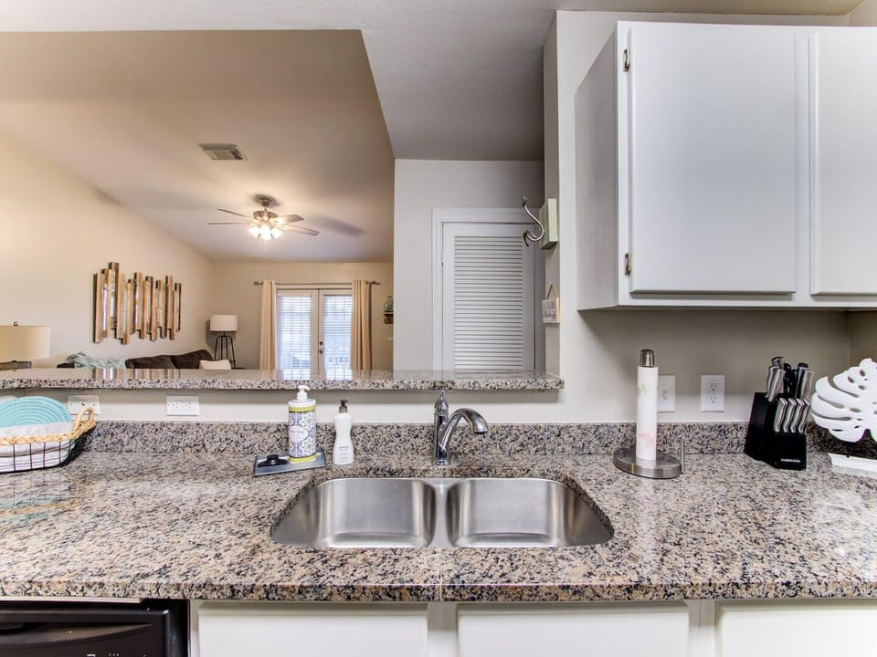 The double sink and beautiful countertop add to the stylish functionality of the space.