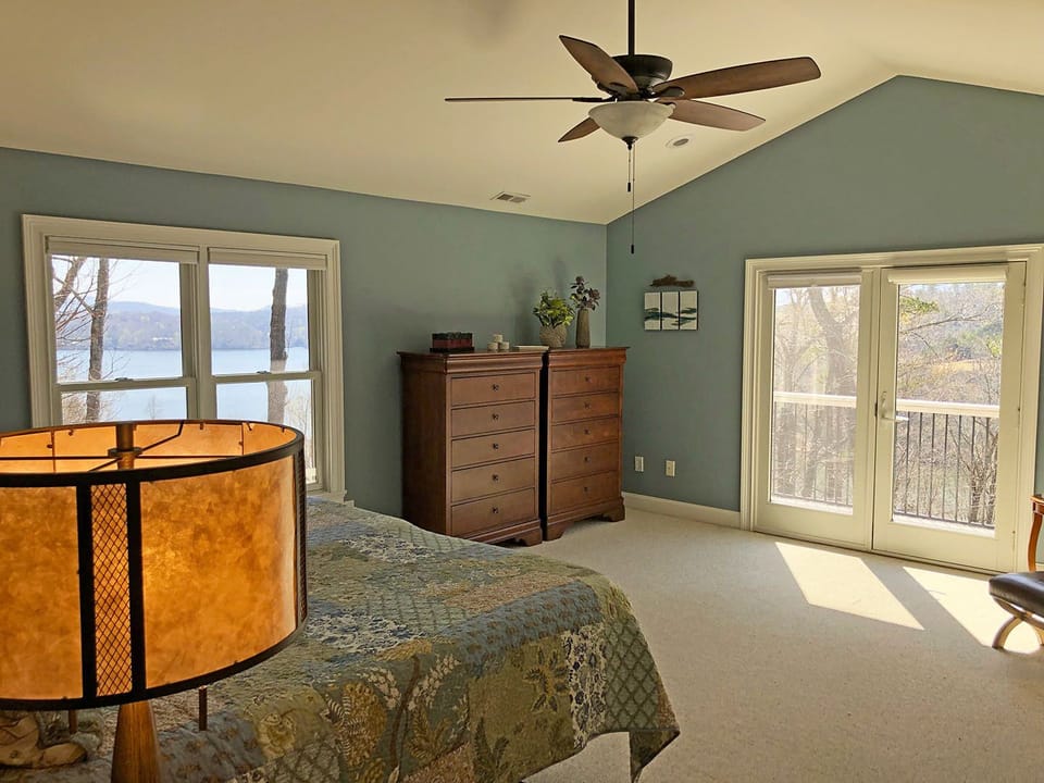 Master Bedroom glass doors open to the private deck with lake and mountain views.