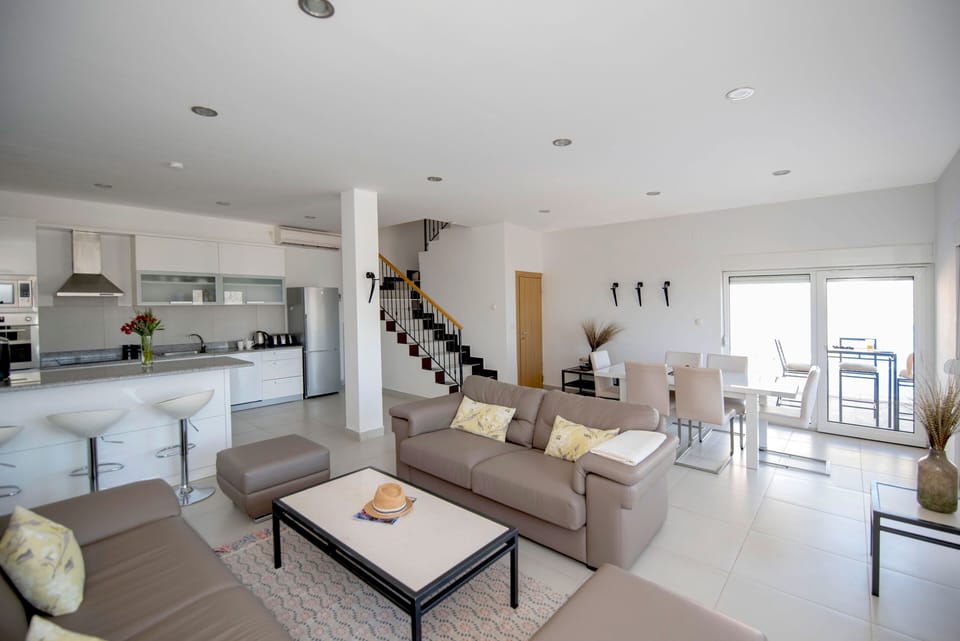 Lounge area opening onto the terrace and view to the sea