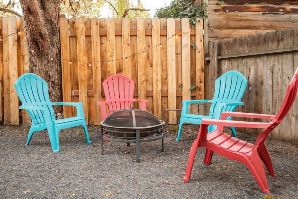 Second fire pit with Adirondack chairs on the lawn