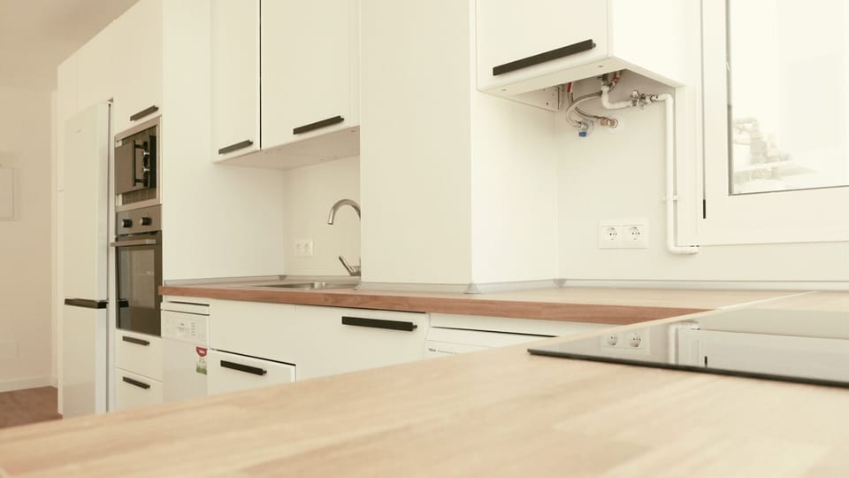 Bright kitchen with dishwasher, stove, microwave and dishwasher