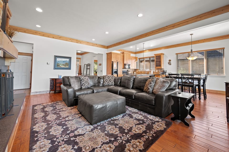 The open-concept living space, complete with a dining area, facilitates effortless conversation with family and friends.