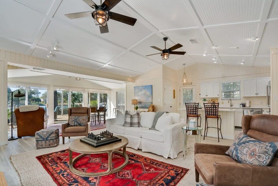 Living room with chess and real wood burning fire place, as well as Smart TV and Queen size pull out couch overlooks the dining area and the intracoastal waterway.
