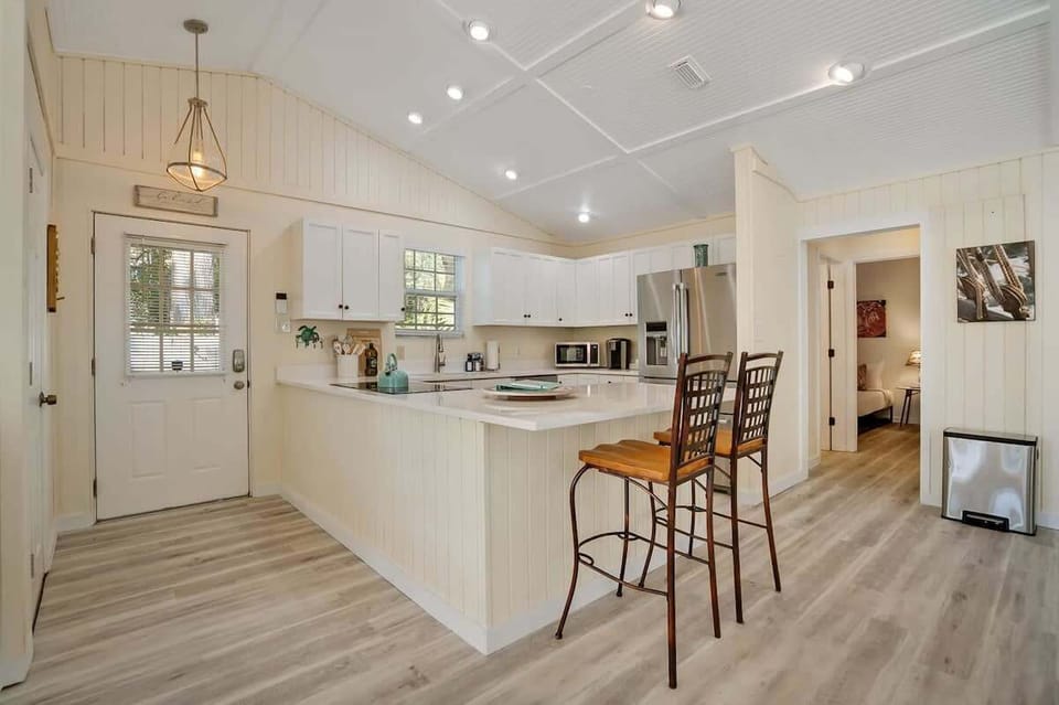 Kitchen with island bar, fully stocked for your entertaining needs.
