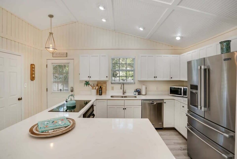 Kitchen with island bar, fully stocked for your entertaining needs.