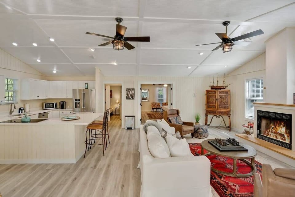 Living room with chess and real wood burning fire place, as well as Smart TV and Queen size pull out couch