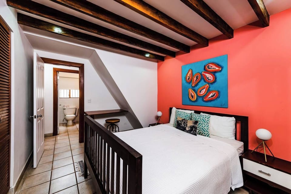 Guest Bedroom #1 is a luxurious suite featuring a king-size bed, elegant décor, and abundant natural light—ideal for families or friends staying at your Tamarindo beach vacation rental.