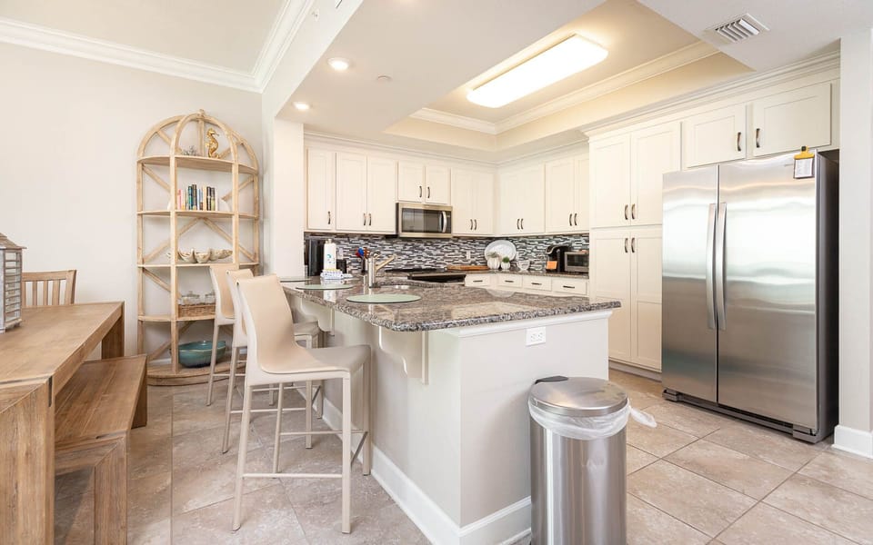 Sip your morning coffee at the breakfast bar and get ready for a beach day in this stylish space