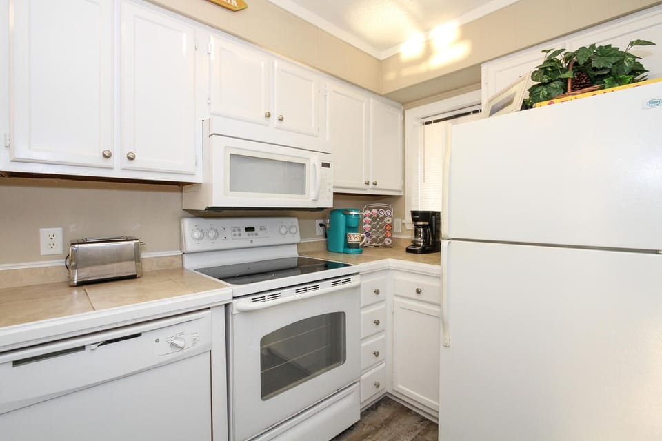 Full sized kitchen with all appliances and plenty of dishes and cookware 