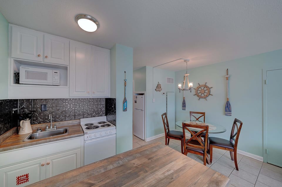 Kitchenette and dining table with 4 chairs.
