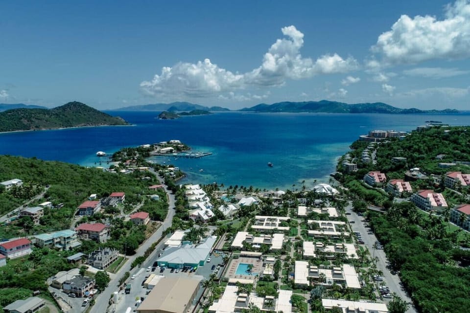 An aerial view of Pineapple Village, with St. John in the background, and Coral World Marine Park to the left.