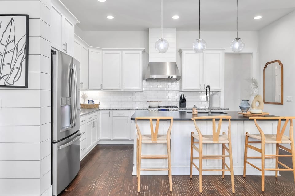 Gourmet kitchen with island seating and stainless appliances (main house)