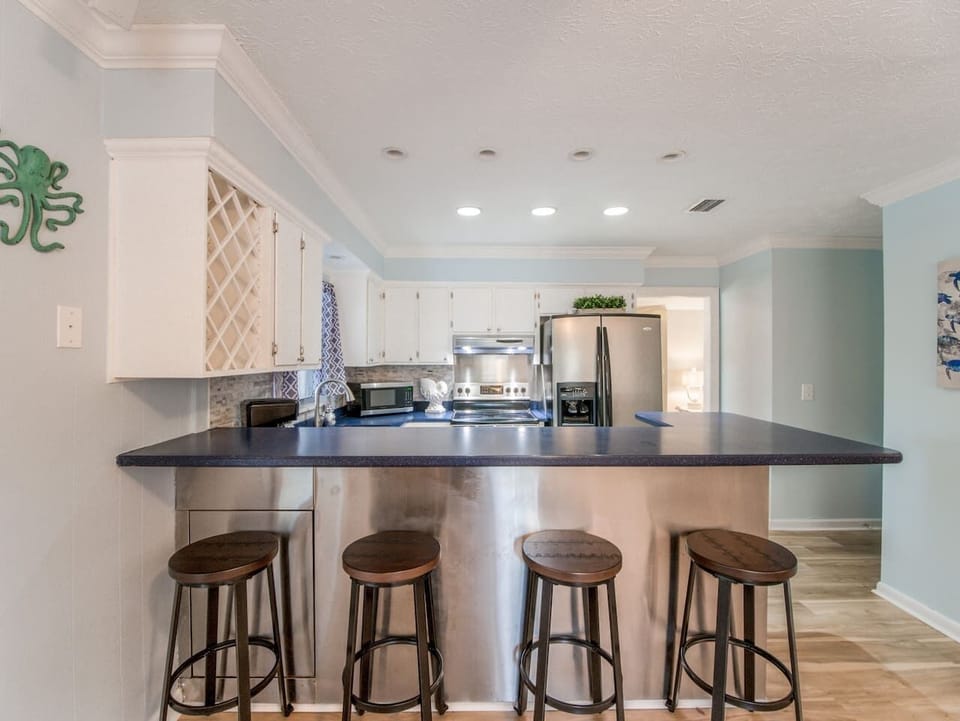 Kitchen with bar seating, modern appliances, and spacious countertops