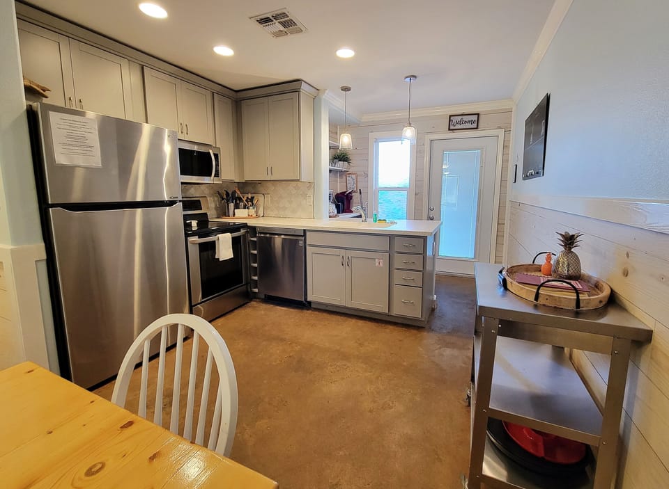 The kitchen features stainless appliances and a coffee bar.