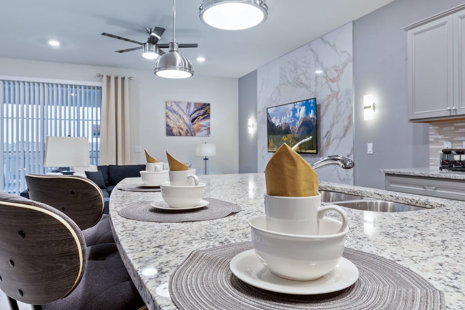 Inviting breakfast bar with elegant place settings and granite countertop.