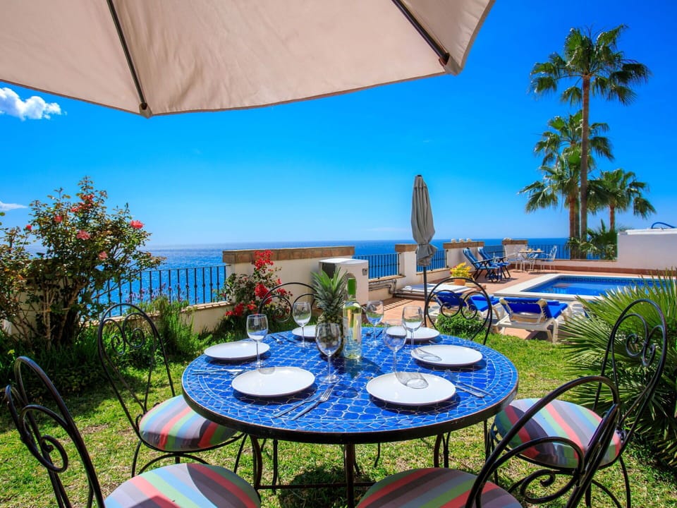 Plant, Table, Furniture, Property, Sky, Building, Umbrella, Azure, Nature, Chair