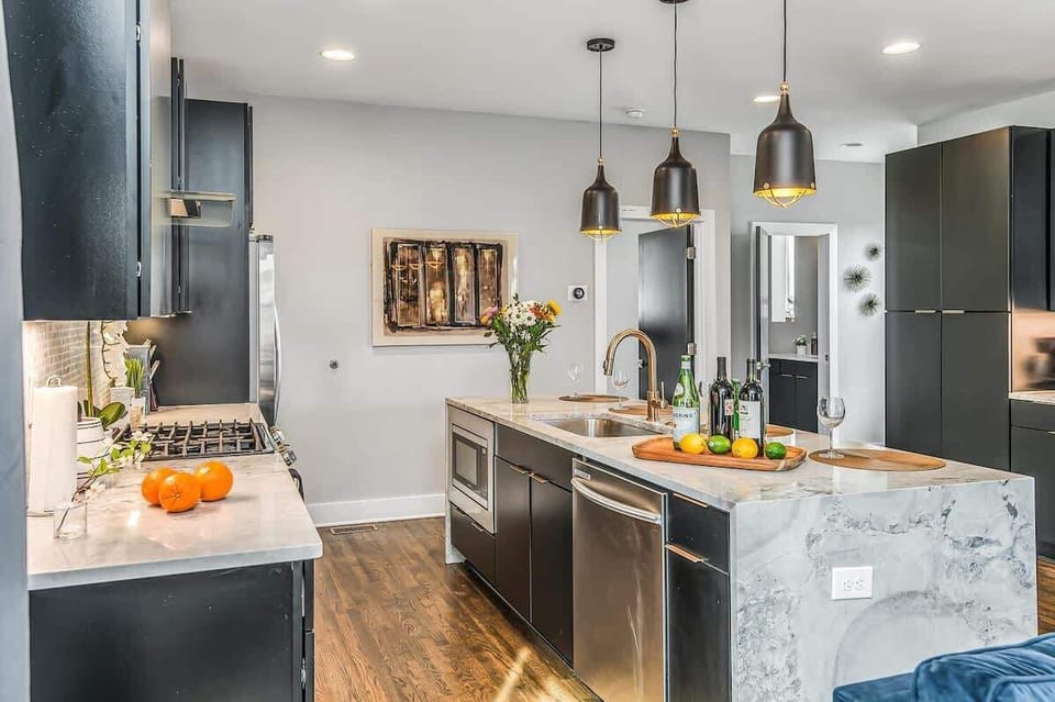 Sit, eat, or play at the kitchen island, designed for comfort and convenience with a dishwasher and sink