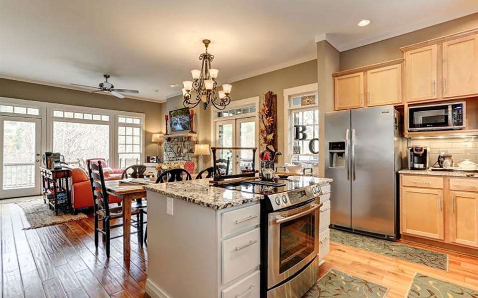 Open-concept kitchen and living area with modern appliances.