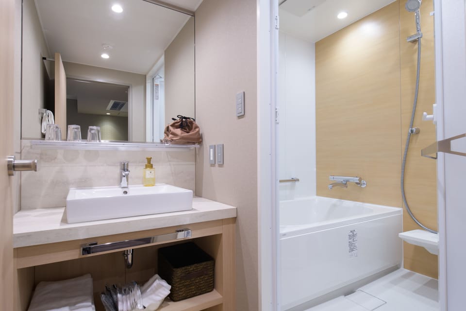 Combined shower/tub, free toiletries, hair dryer, slippers