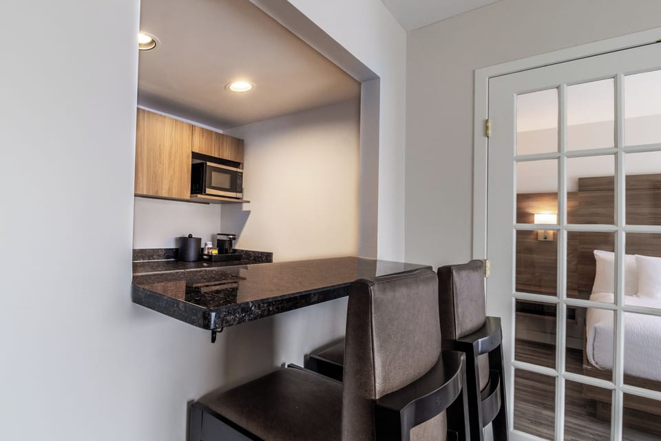 Suite, 1 King Bed with Sofa bed, Kitchenette, Corner | Living area | 50-inch Smart TV with cable channels