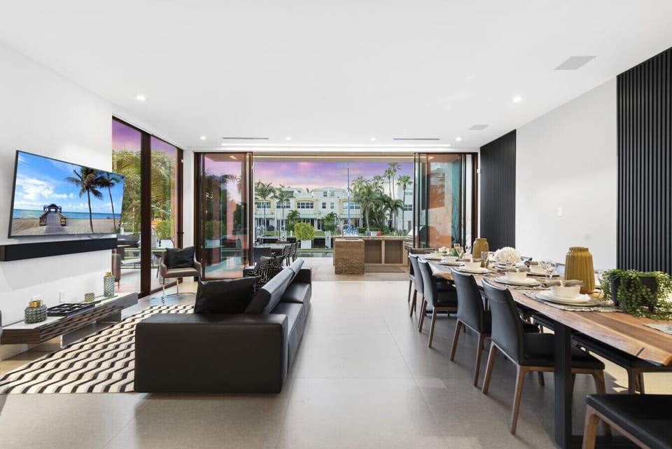 Contemporary gathering space with comfortable sofas, dining for ten, and scenic backdrop