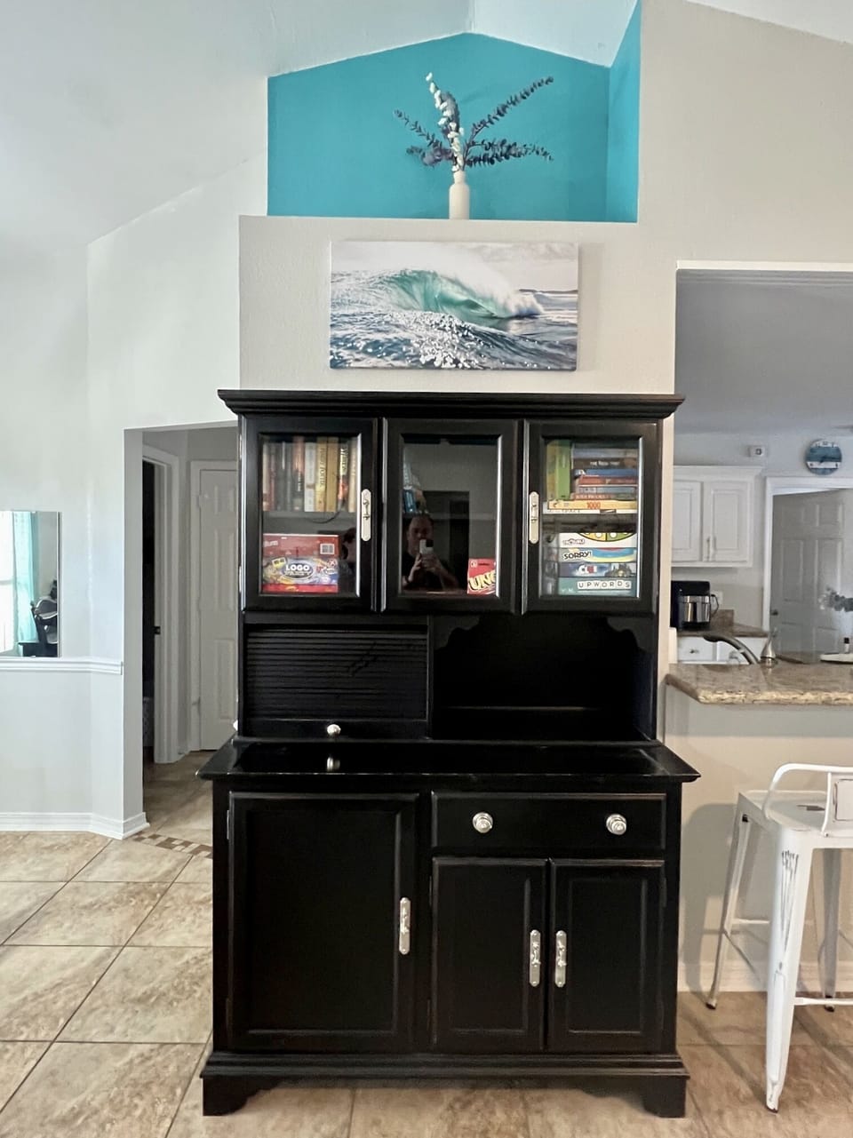 Cabinet stocked with board games, playing cards, and books. Perfect family fun for the rare rainy day on The Emerald Coast..