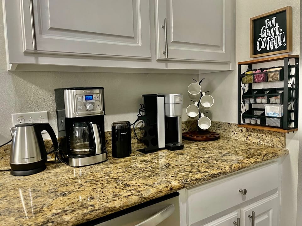 Gourmet coffee/tea area with Keurig, bean grinder, drip coffee maker, and tea kettle. An assortment of Keurig pods, teas, and hot chocolate are complimentary for your stay.