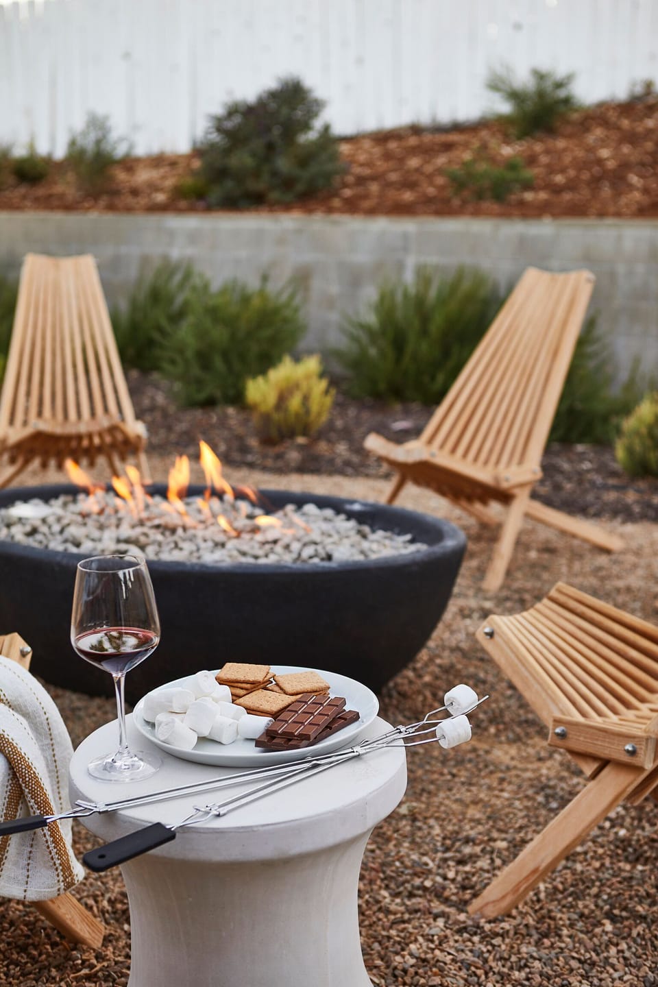 A gravel fire pit area is set up for relaxed nights outdoors