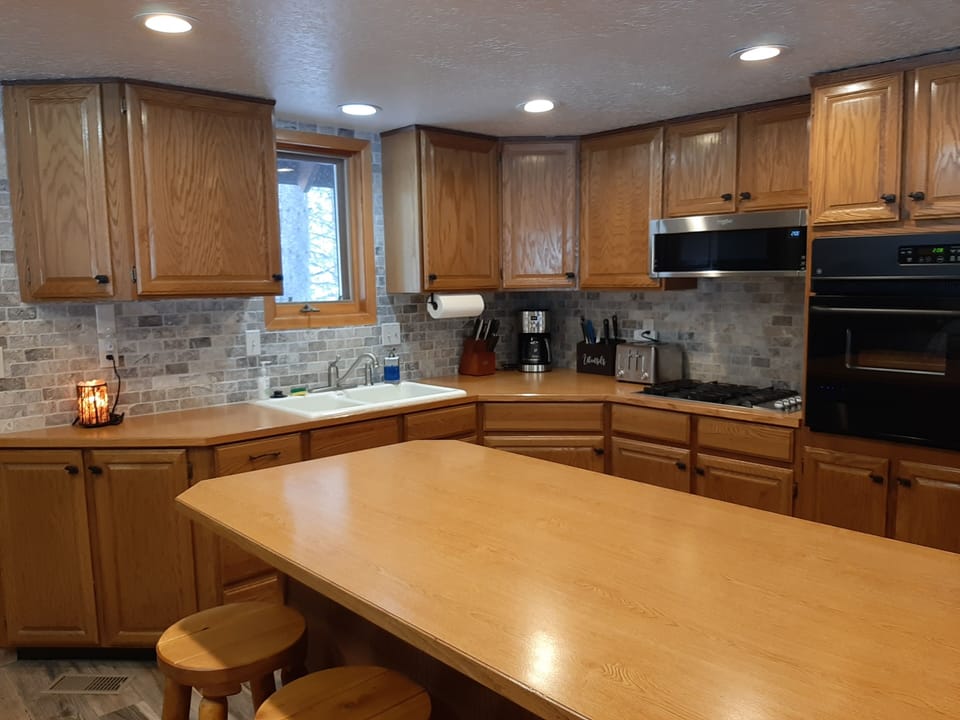 Kitchen with all the appliances and dishes  you need to make any meal.