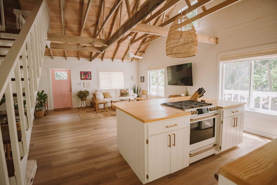 Large kitchen island featuring GE Café gas range.
