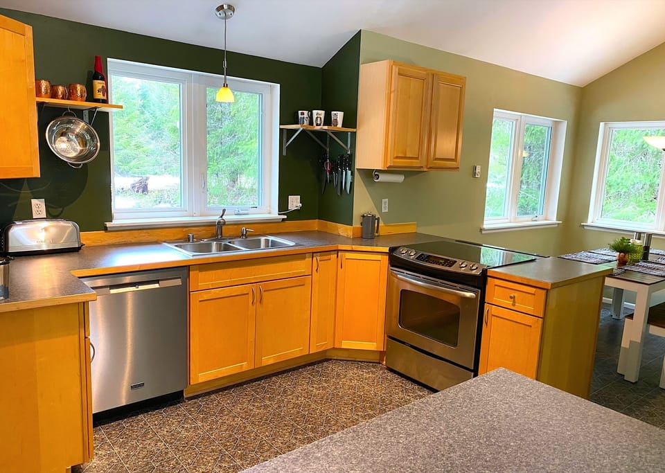 Open kitchen supports chatting in the dining and living areas.