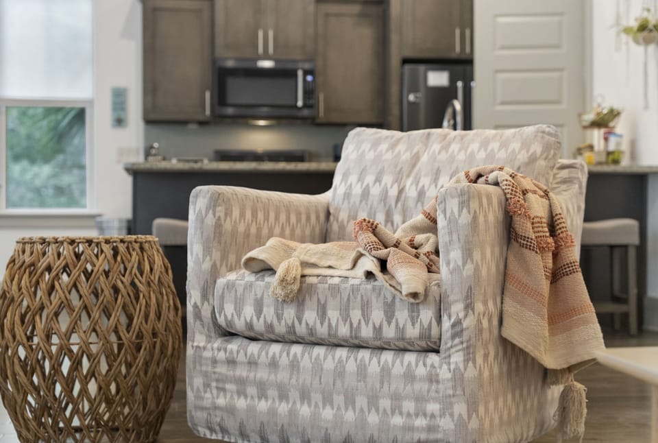The living room features a 65 inch Samsung smart TV and plenty of seating for gathering.