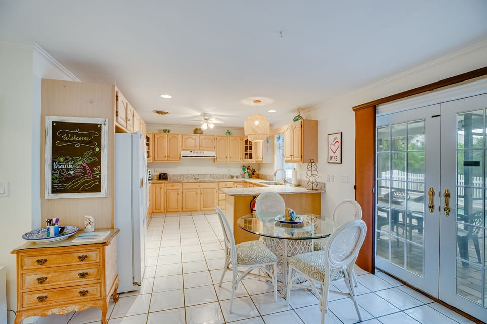 Full kitchen complete with stovetop, oven, toaster, drip coffeemaker and Keurig.