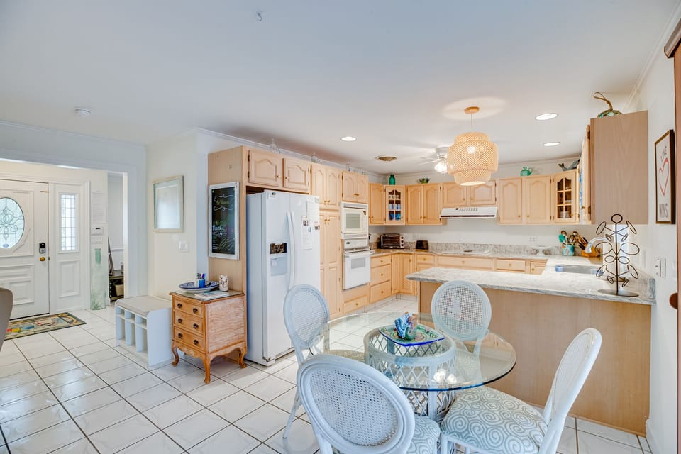 Side-by-side refrigerator has filtered water, additional fridge in garage.