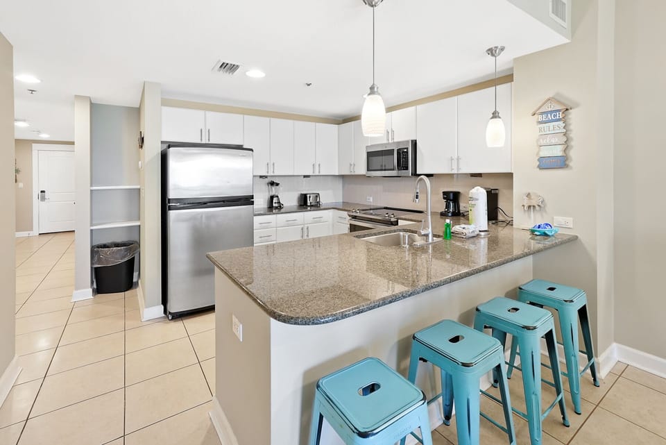 Your fully equipped kitchen with granite counters and breakfast bar creates the perfect space for vacation meal prep and casual dining.