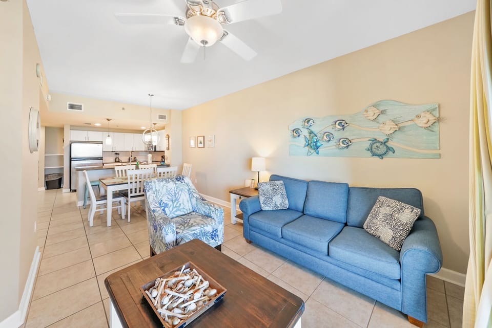 Unwind in your bright living space with coastal decor and open kitchen, perfect for relaxing after beach days.