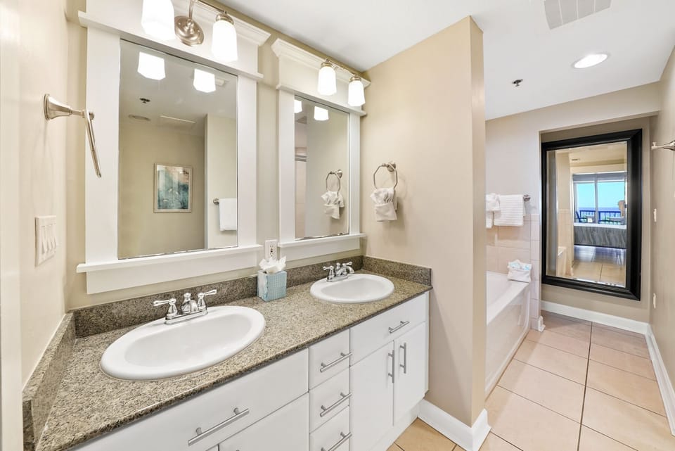 Your spacious bathroom features dual vanities with elegant granite countertops, perfect for getting ready together each morning.