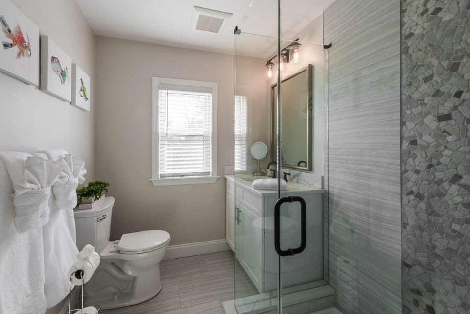 Full bathroom, fully equipped with towels, shampoo, conditioner, and body wash.