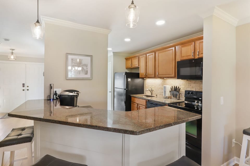 Kitchen with stainless steel appliances and bar stools!